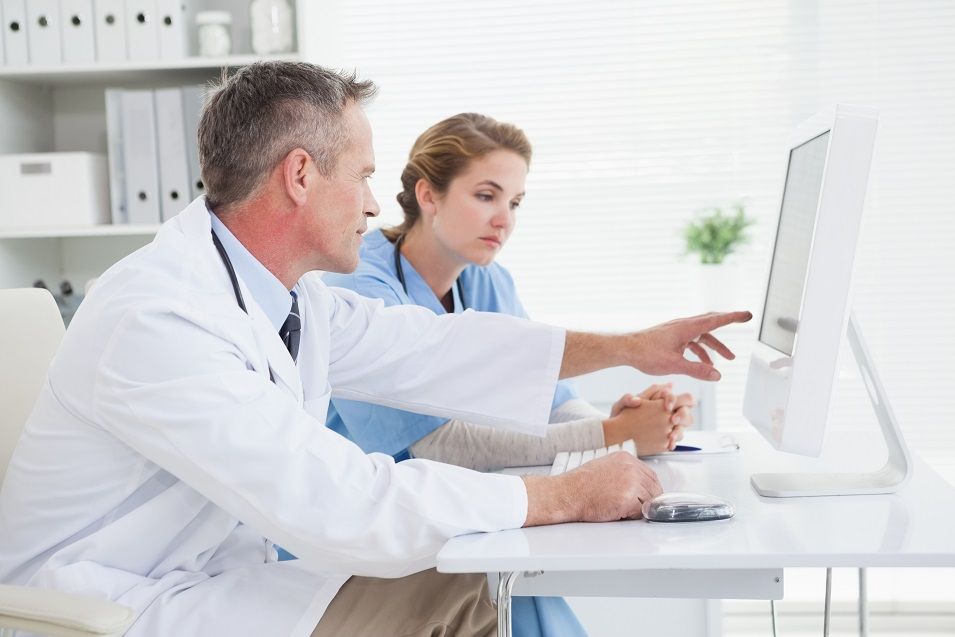Doctor and nurse looking at computer